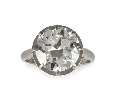 an old cut diamond ring on a white background
