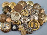 a pile of gold and silver buttons on a table