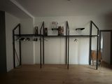 a room that has a shelf with clothes on it