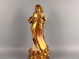 gold statue of a woman holding a baby in her arms