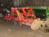 a picture of a tractor and a plow in a barn