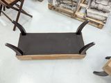 a wooden bench that is sitting on the floor