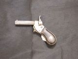 a small knife that is laying on a piece of cloth