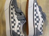 a pair of grey and white shoes on a wooden floor