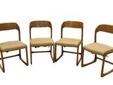 four wooden chairs are lined up in a row on a white background