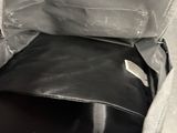 a black and white photo of a purse inside of a bag