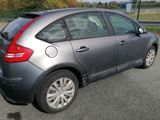 a silver car that is parked on the side of the road
