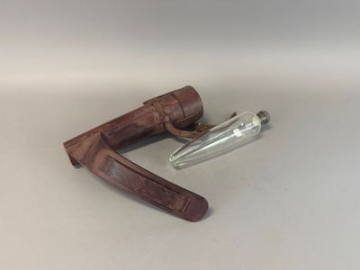 a knife and a glass bottle on a table