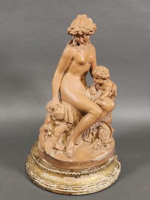 statue of a woman sitting on a rock with a child