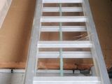 a ladder that is sitting on the floor next to a table