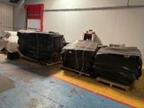 many pieces of luggage sitting on pallets in a warehouse