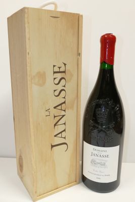 a bottle of wine in front of a wooden box