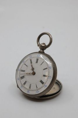 a silver pocket watch with roman numerals on it