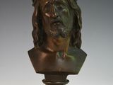 bronze bust of jesus on a pedestal on a white background