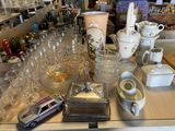 a lot of glassware on a table in a store