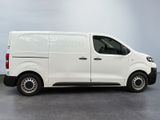 the white van is parked in a room with a gray floor