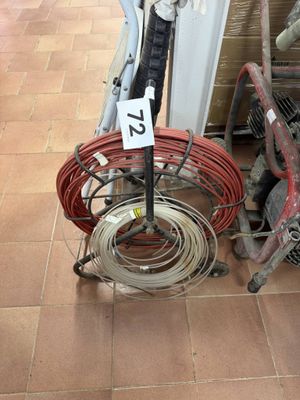 a bicycle that is sitting on the floor next to a pile of wires