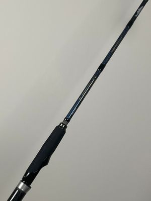 a close up of a fishing rod on a white surface