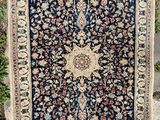 an antique persian rug on display in a garden