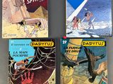 four children ' s books on a table, one of which is a picture of a man and a woman
