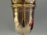 a silver goblet on a stand on a gray surface