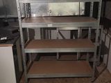 a kitchen with a stove and shelves in it