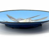 a blue bowl with a bird in it on a white surface
