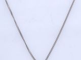a necklace with a pear shaped diamond on a chain