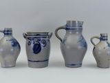 three blue and white vases sitting next to each other on a white surface