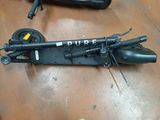 a scooter that is sitting on the floor next to a suitcase
