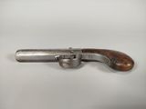 an old gun with a wooden handle on a white surface