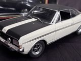 a model of a white and black car on a table