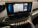 a car dashboard with a monitor and a steering wheel