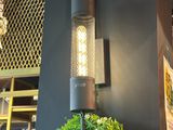a potted plant on a table in front of a wall light