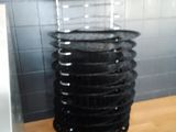 a stack of black plates on a metal stand