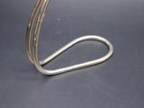 a metal hook that has been placed on top of a table