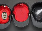 three hats are lined up in a row on a black surface