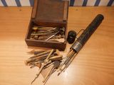 a box of tools on a table with a wooden box