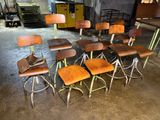 a lot of wooden chairs and stools in a room