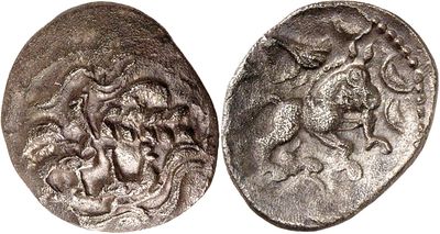 a close up of two silver coins on a white surface
