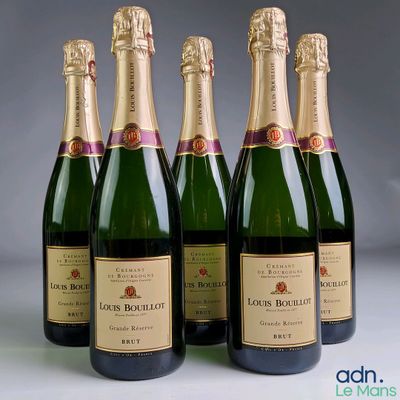 four bottles of champagne are lined up in a row