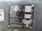 a sign on the side of a machine that has a lot of screws