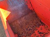 a red dump truck with dirt inside of it