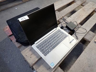 a laptop computer sitting on a pallet on a wooden pallet