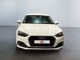 the front of a white audi car in a showroom