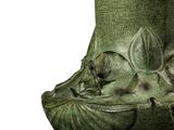 a green vase with a bird on it on a stand