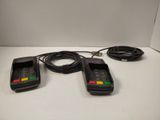 three cell phones are sitting on a table with a cord