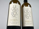 two bottles of wine sitting next to each other on a table