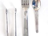 a spoon, fork, and spoon rest on a white surface