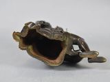 a bronze figurine of a woman sitting on a shell